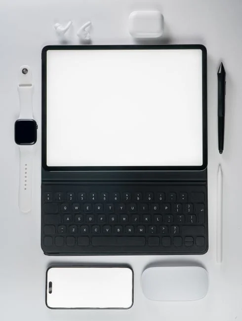 Dual monitors on a desk, showcasing web design in a modern office setting.